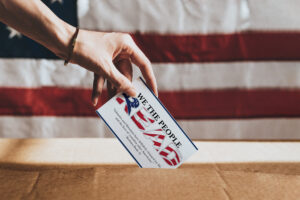 A hand placing a postcard labelled with 